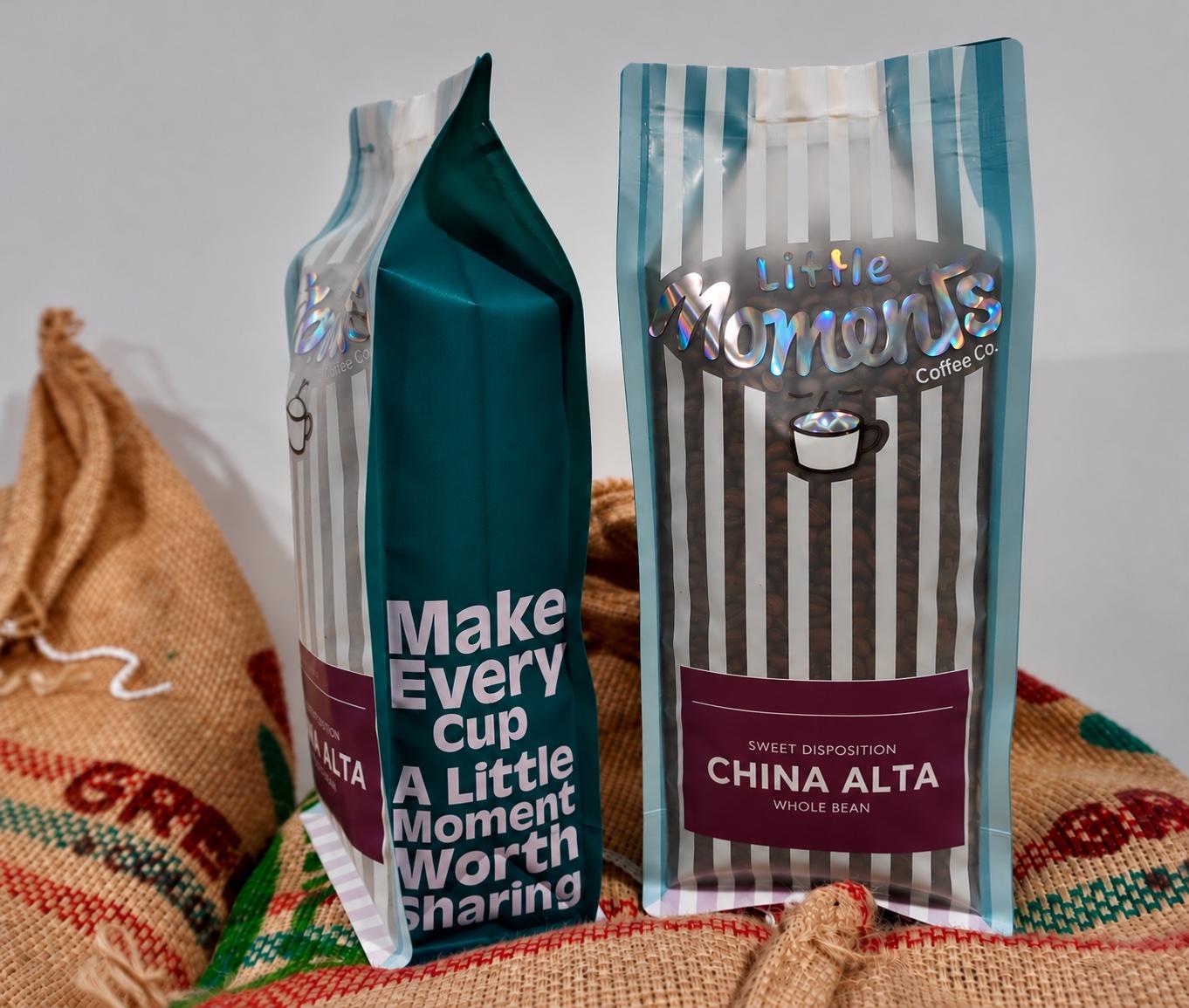 Two bags of China Alta standing on jute coffee sacks