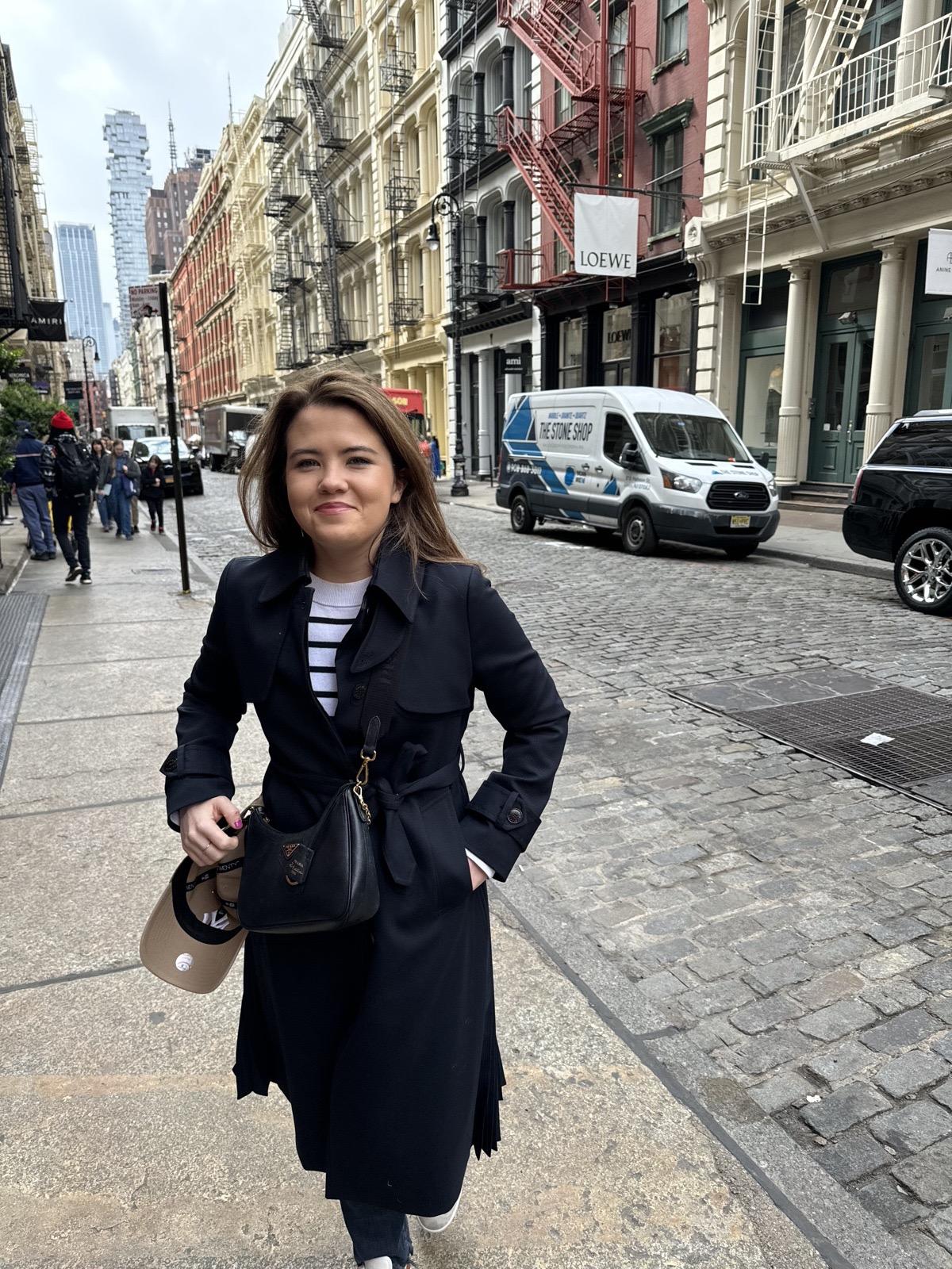 Erin walking along a cobbled street in New York